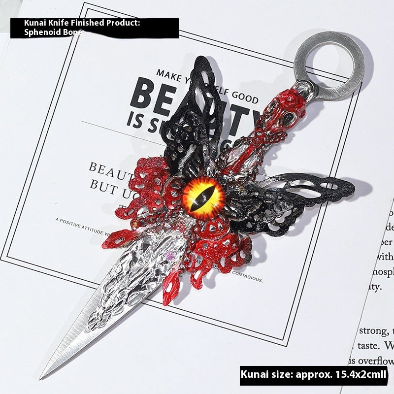 Decorative Athame with red and black design on a magazine background