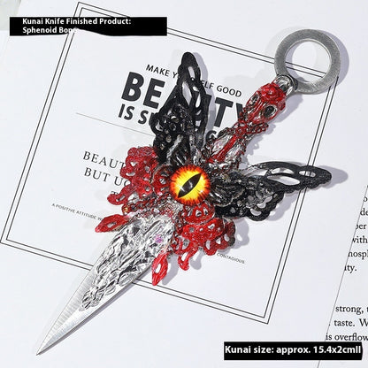 Decorative Athame with red and black design on a magazine background