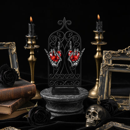 Pair of Heart in Rock Skeleton hands on gothic display.
