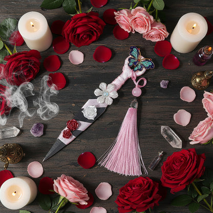 Decorative Athame with butterfly and flower embellishments on a rose laden table