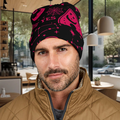 Man wearing a black and hot pink Ouija Board patterned Beanie