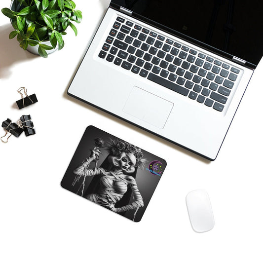The Gift Dimension Bride of the Mummy mouse pad with gothic Egyptian art on a desk next to a laptop and mouse.